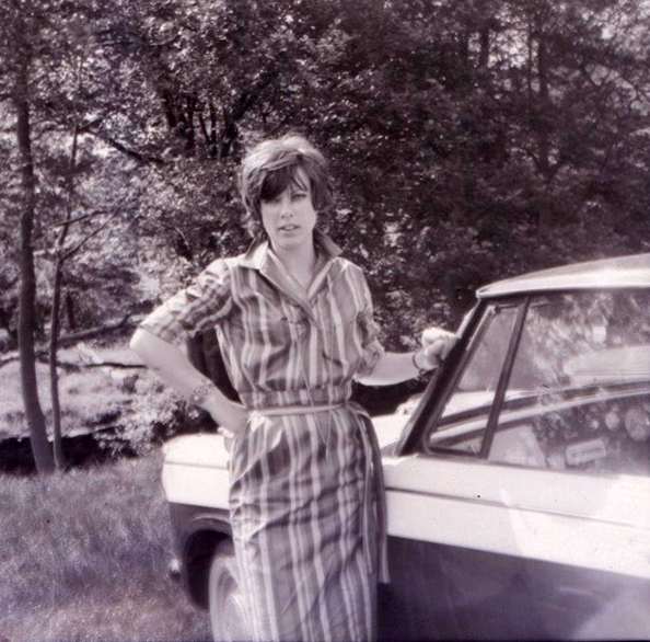 Young woman beside a car