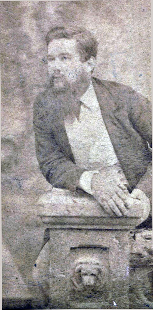 Bearded young man leaning on a pedestal